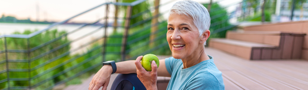WomanEatingAppleBanner